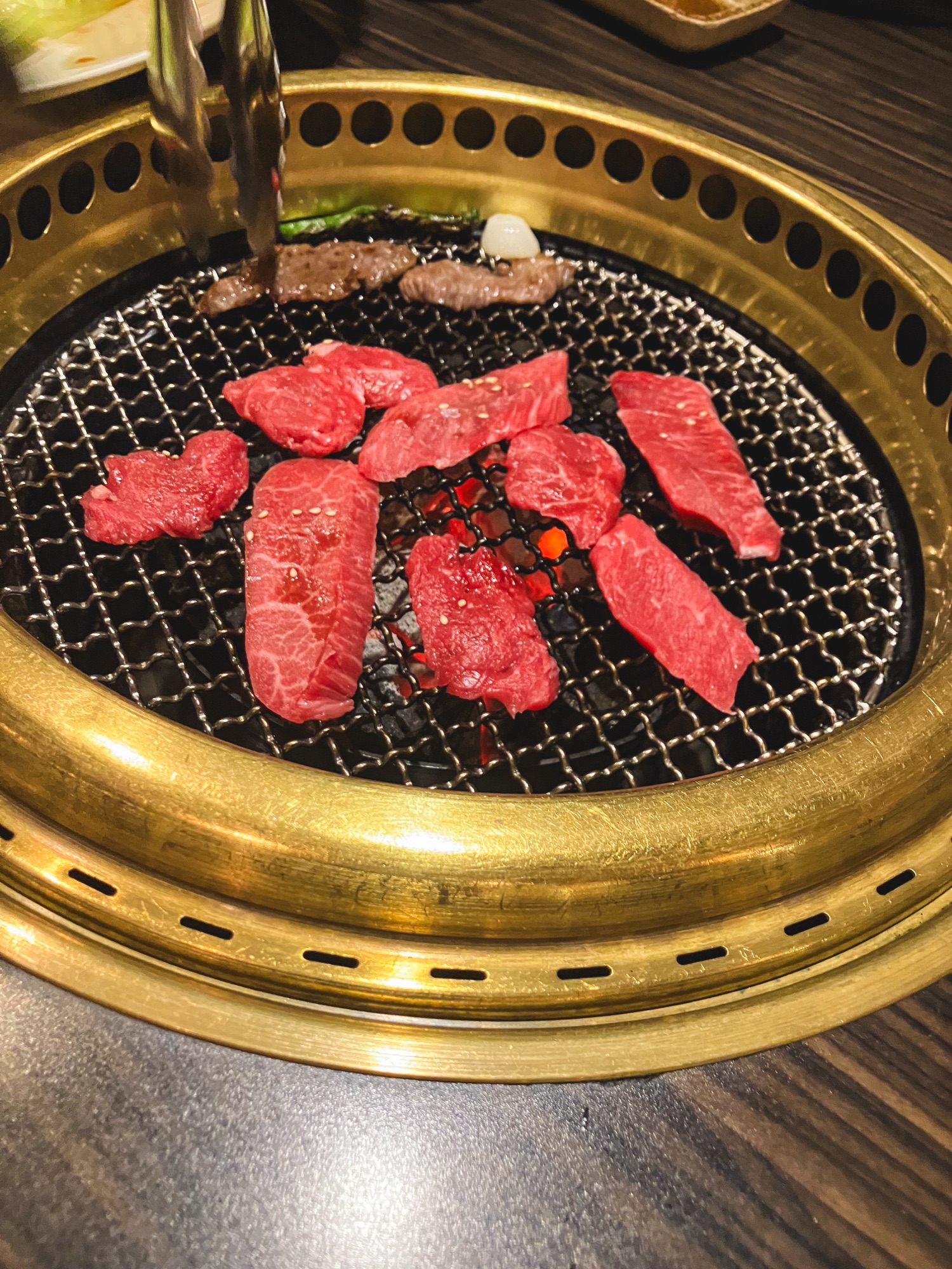 焼肉くろげの炭火の網に並べた赤身の牛肉