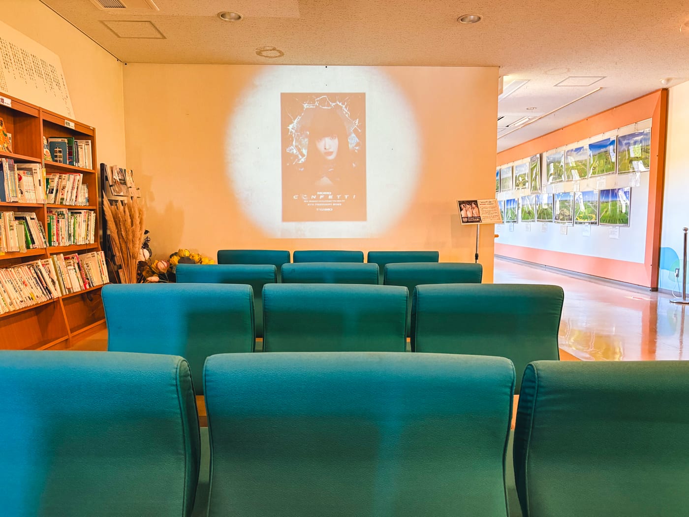 A screen inside Gyoda Tower showing a MISAMO music video