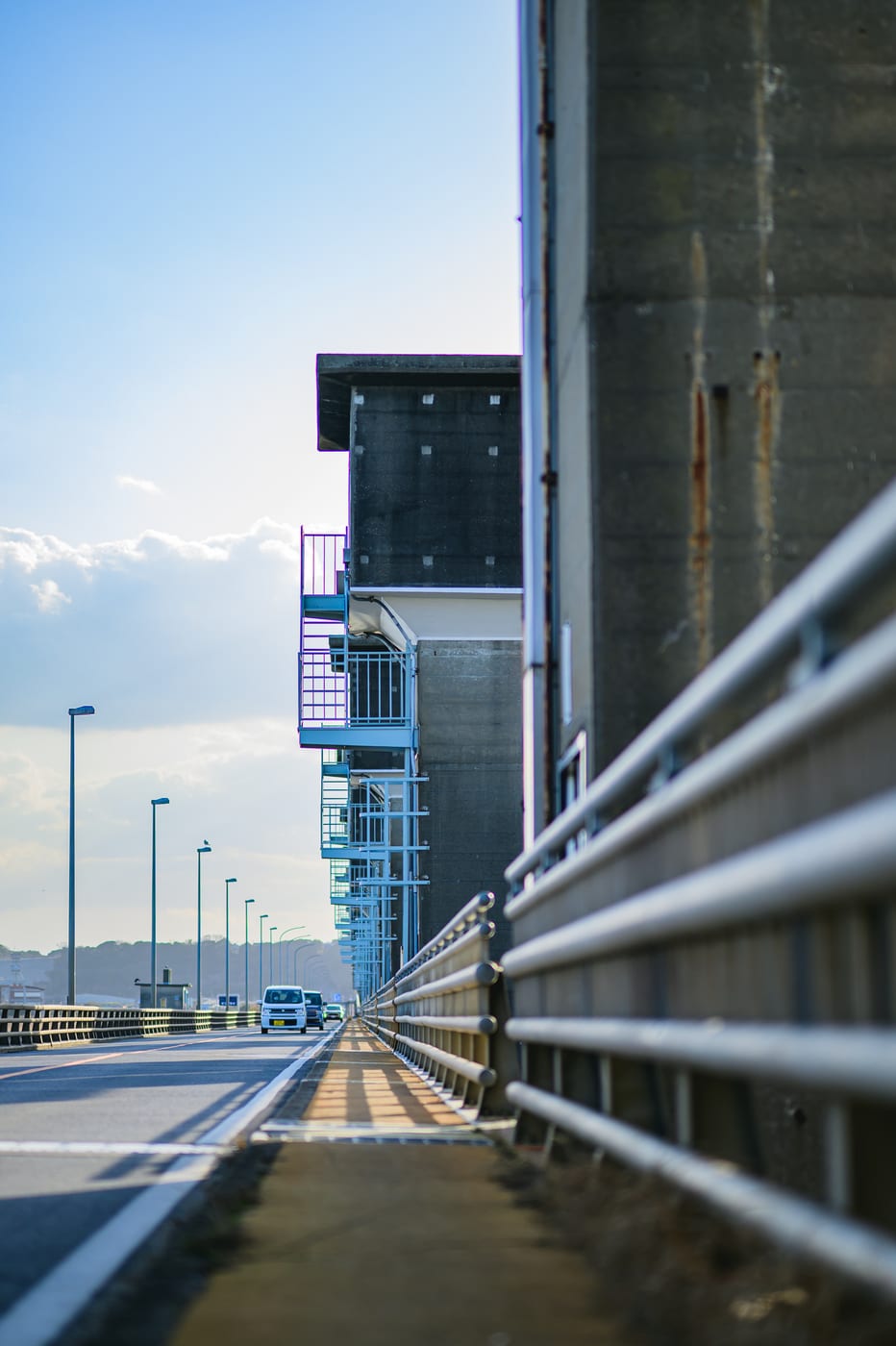 Hitachigawa Bridge stretching straight ahead under a blue sky