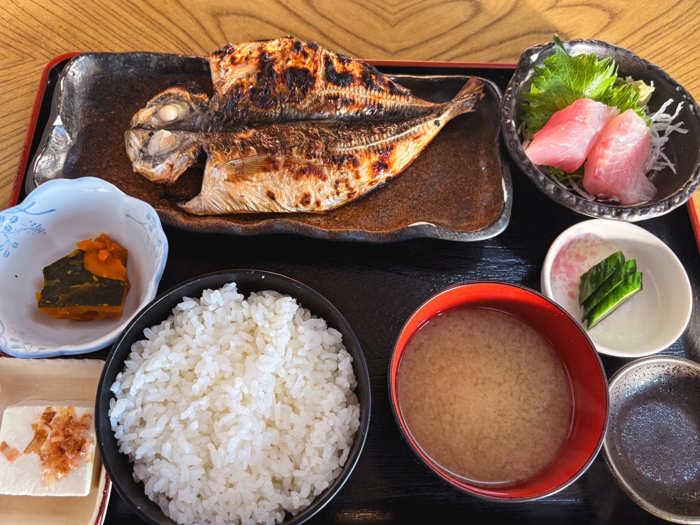 A breakfast set with dried horse mackerel, sashimi, rice, and miso soup