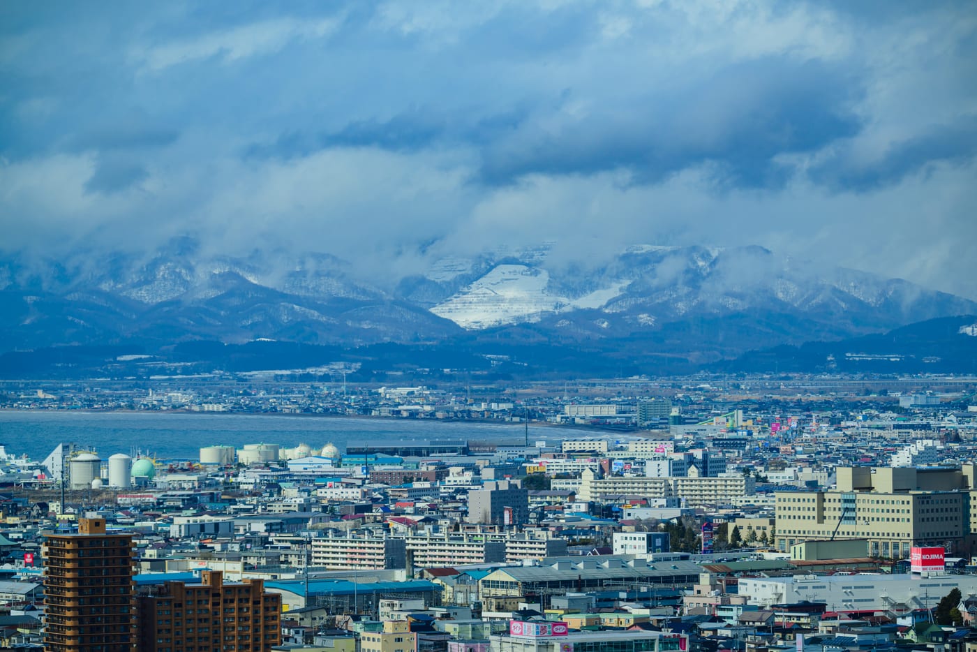 Hakodate's cityscape and cloud-covered snowy mountains viewed from Goryokaku Tower