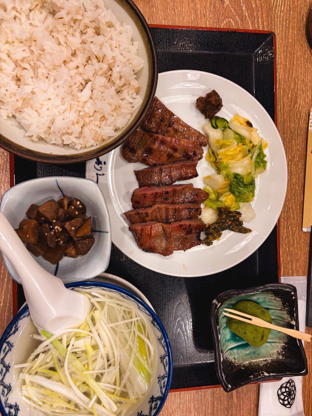 A Rikyu set meal with grilled beef tongue, barley rice, tail soup, and side dishes