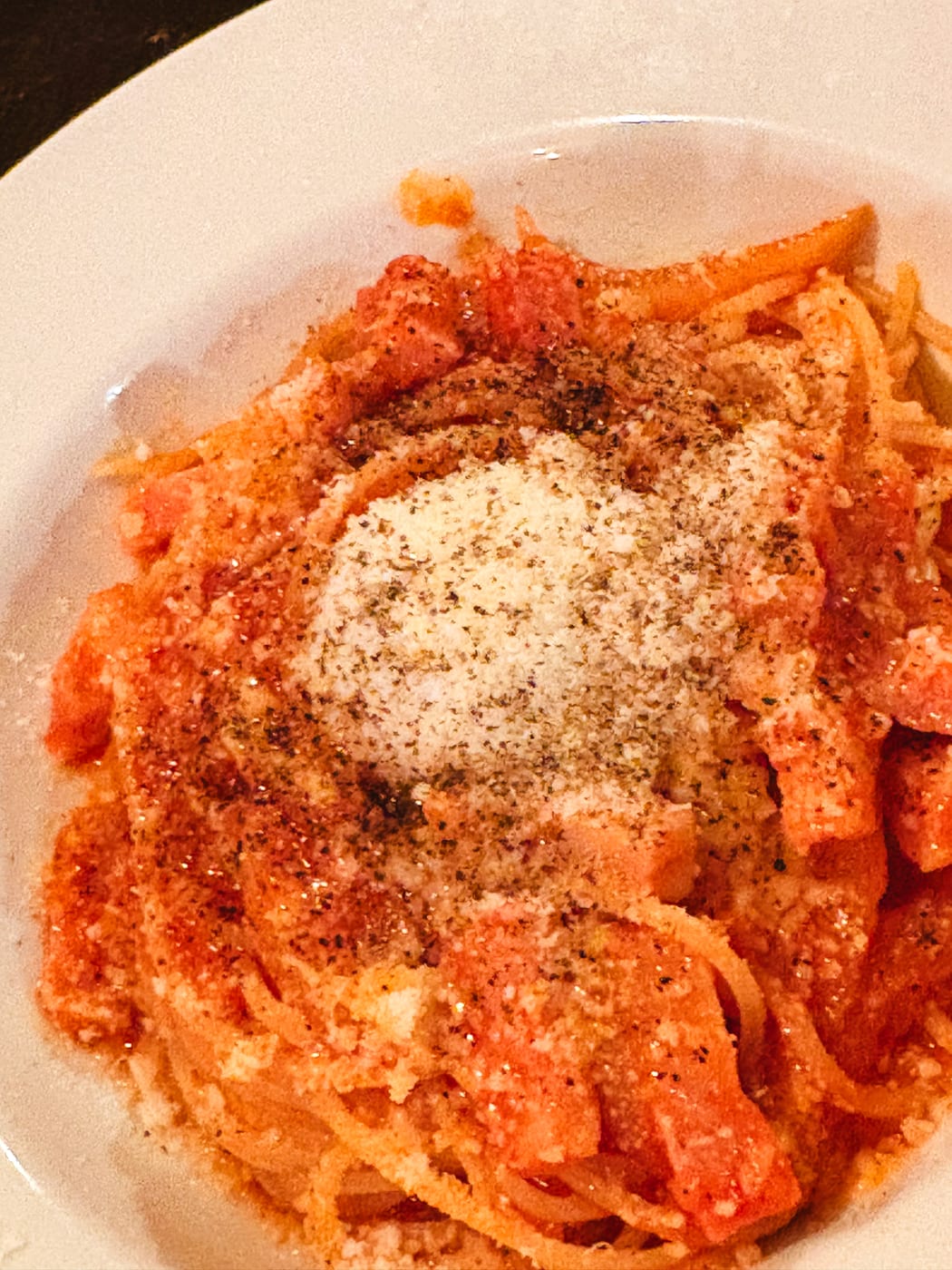 Pasta covered with tomato sauce and grated cheese at suEzou