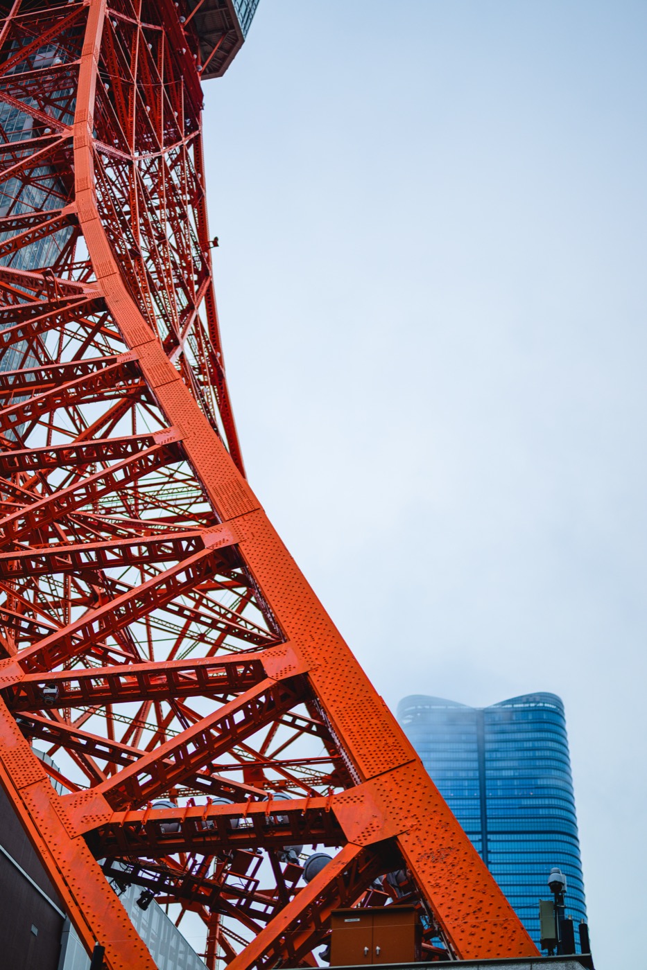 Tokyo Tower's red steel framework with Azabudai Hills behind it