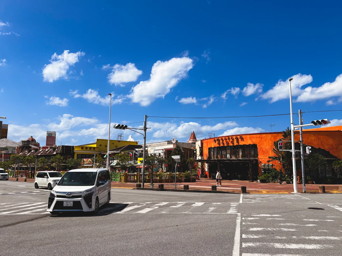 Buildings and a street at American Village beneath a blue sky