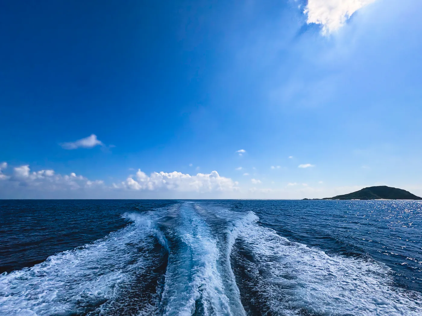 A white wake trailing behind the dive boat
