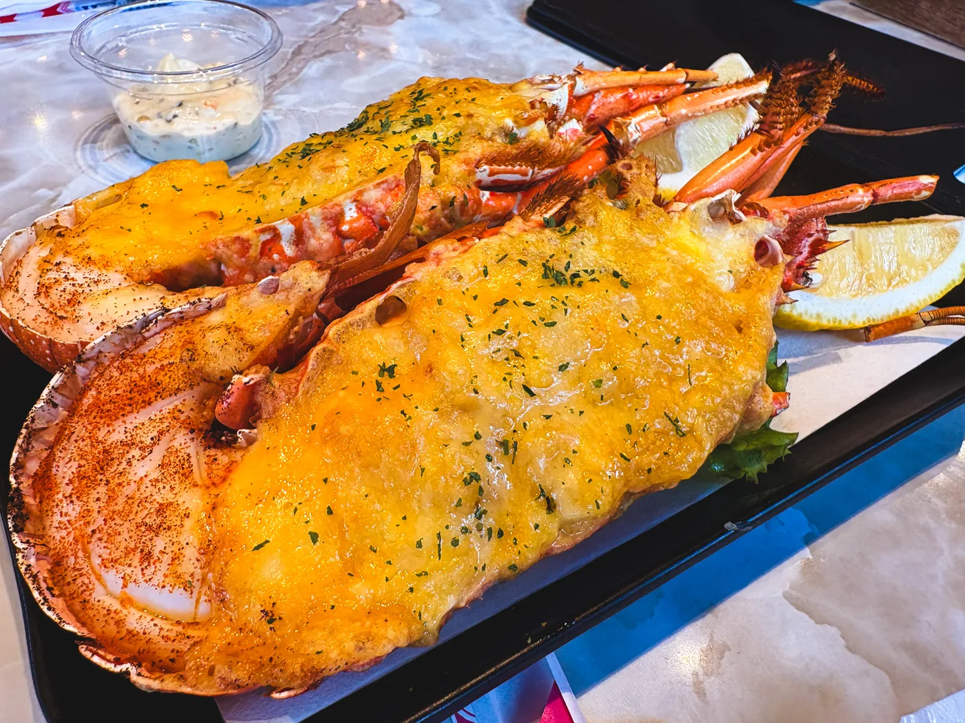 A platter of grilled lobster split in half