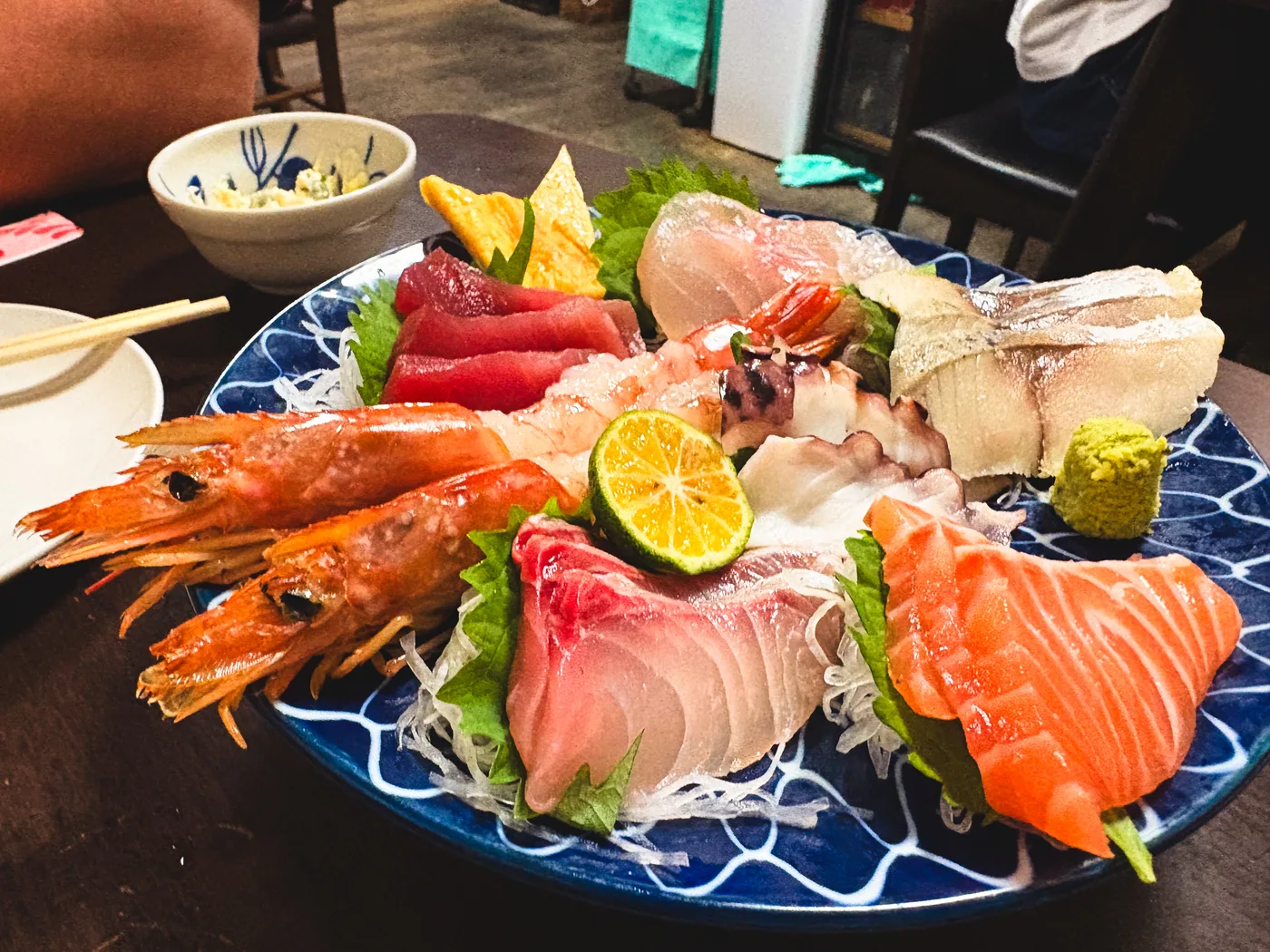 A large platter of assorted sashimi, including shrimp and tuna