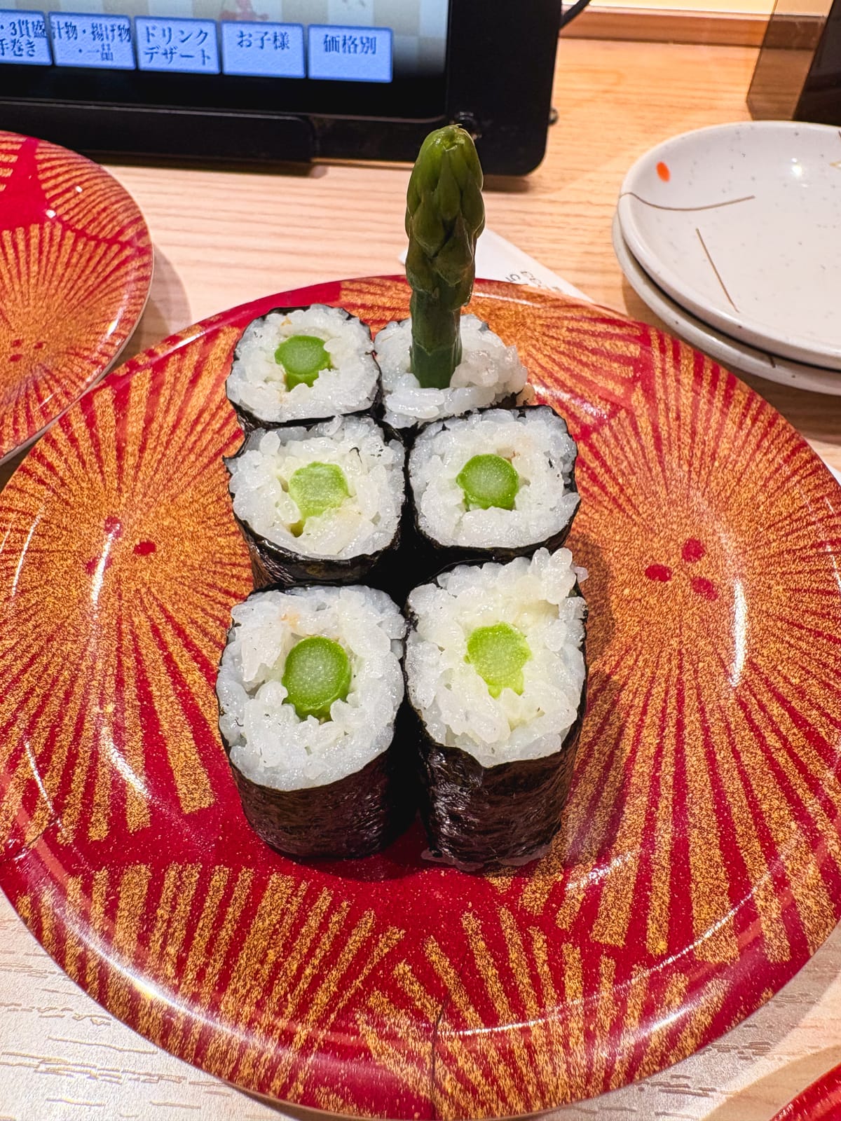 A sushi roll with a whole upright asparagus spear at Nagoyakatei Kitano