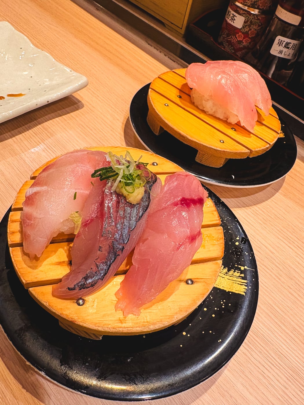 Local-fish nigiri served on a plate at a conveyor-belt sushi restaurant