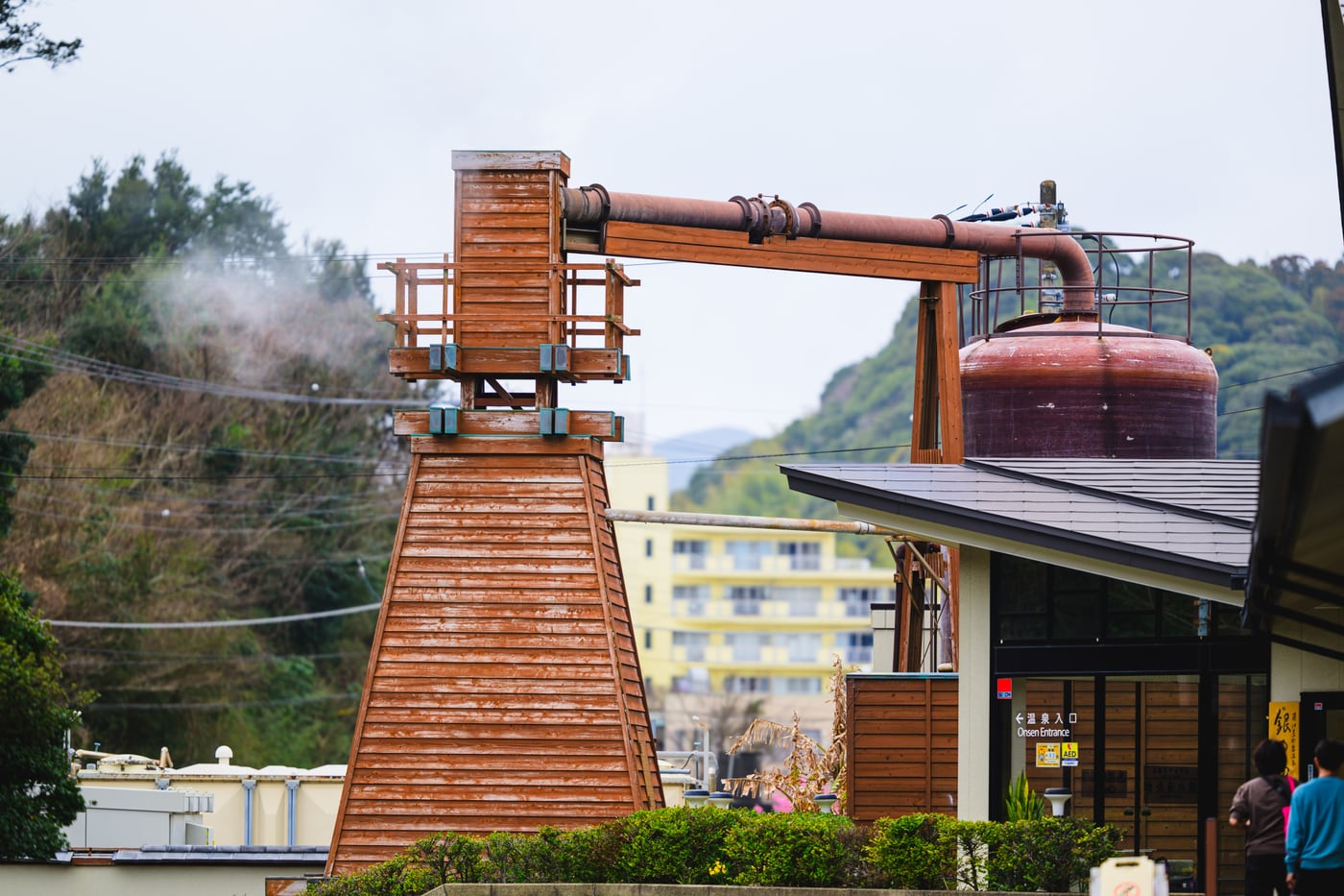 Steam rising beside a wooden hot spring facility in Shimogamo