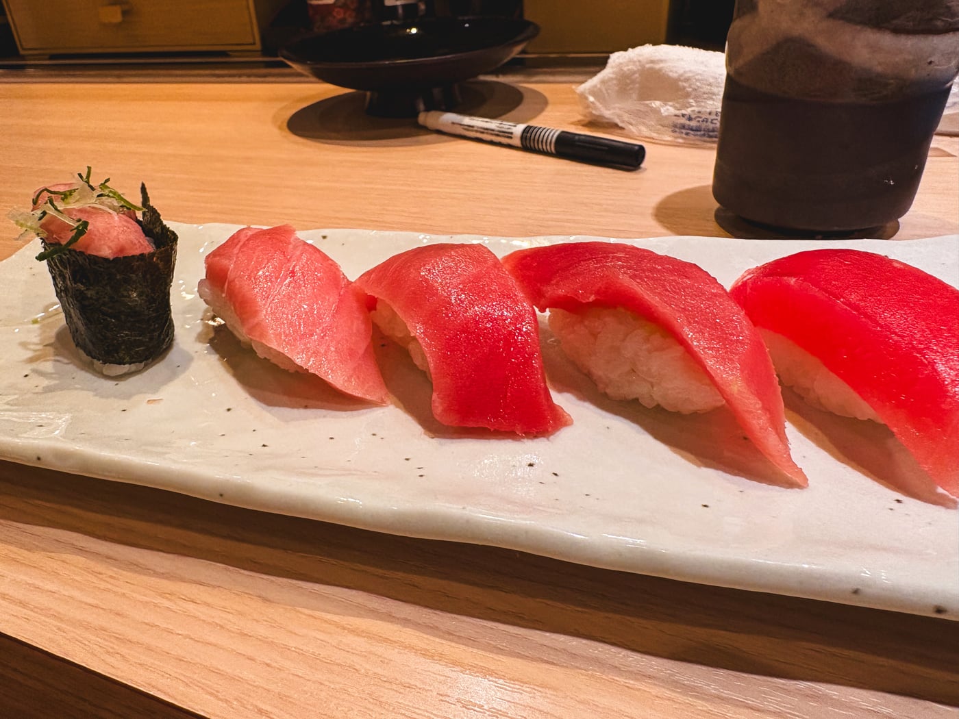 A tuna nigiri set with akami and chutoro lined up on a plate