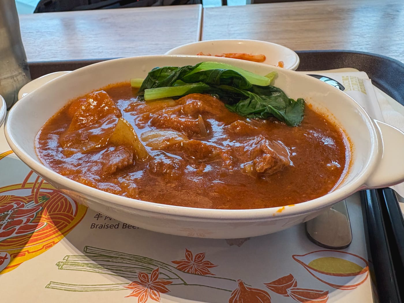 Hongshao niurou fan, a rice dish topped with beef belly in a thick sauce, eaten at Taipei Songshan Airport