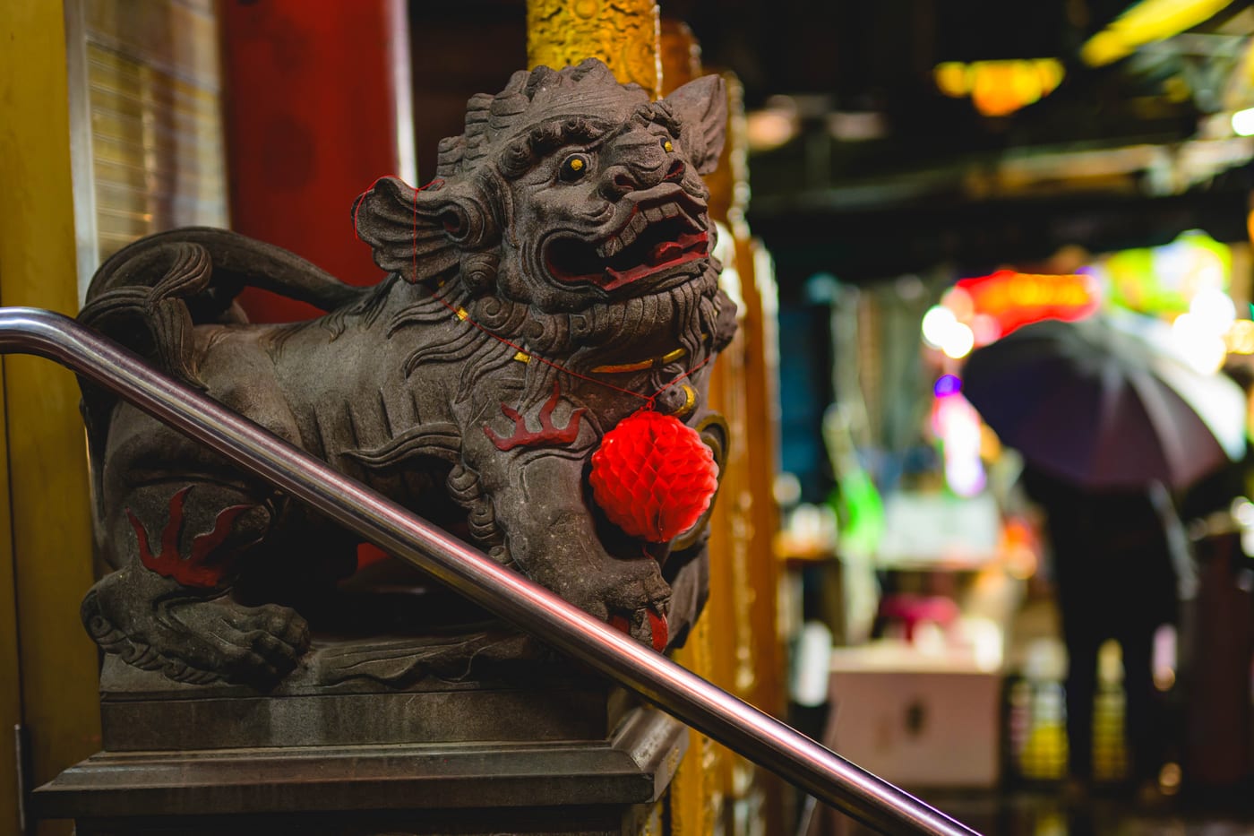 A statue at Shilin Night Market that looks like a komainu or guardian lion-dog, decorated in red