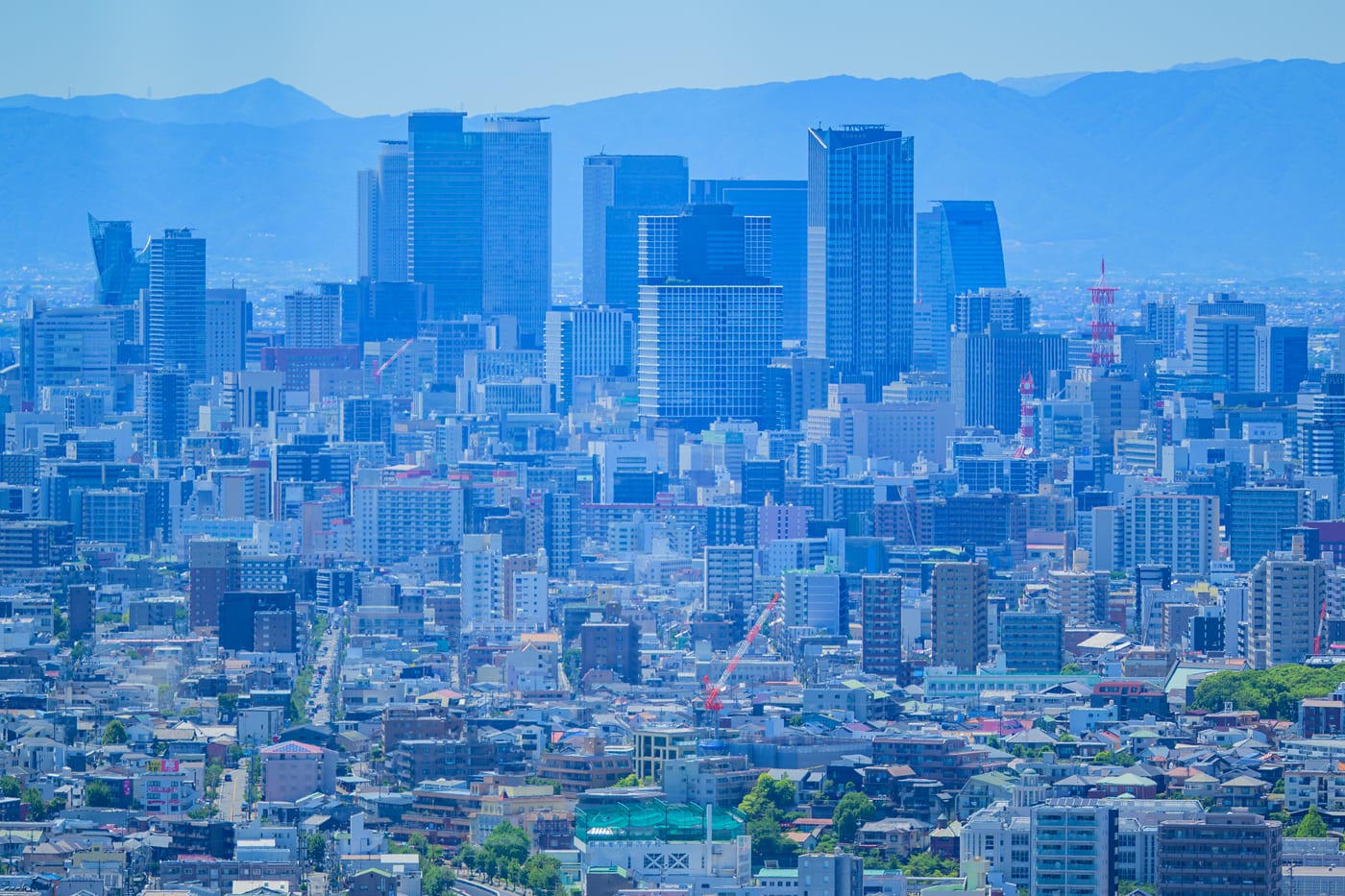 Nagoya's cityscape and tall buildings with mountains in the background