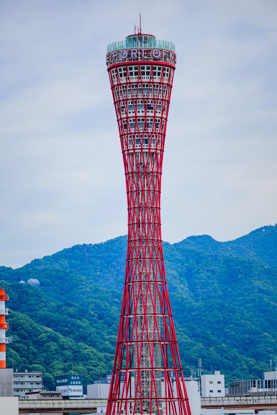 The red Kobe Port Tower standing beyond the harbor