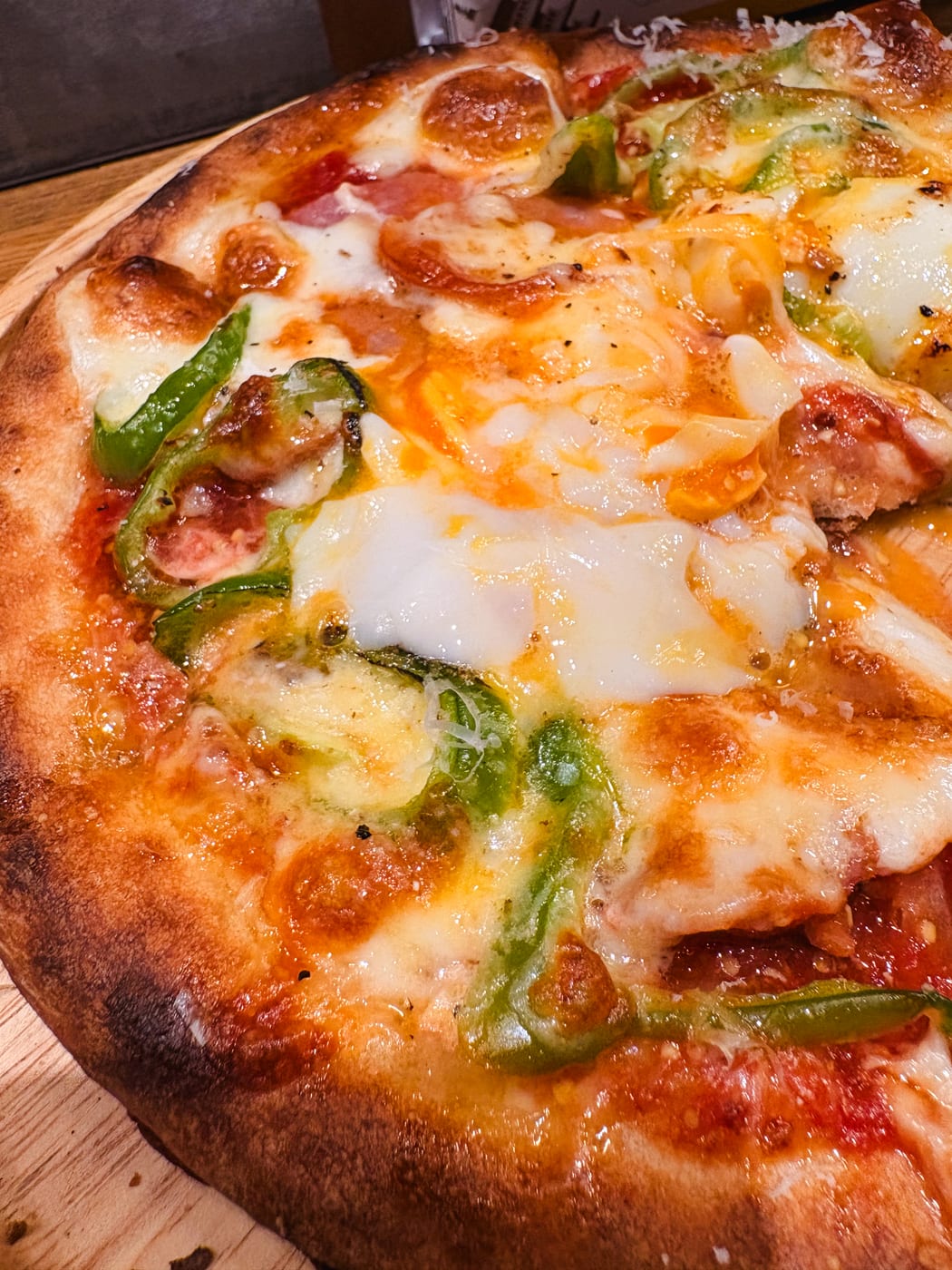 A baked pizza topped with cheese and other ingredients