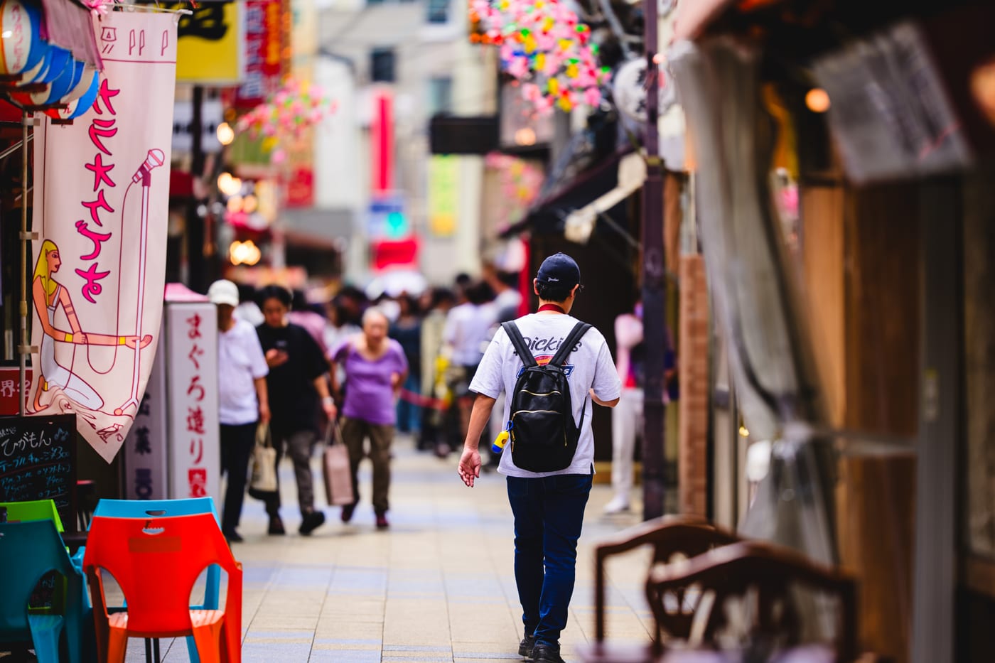 A Shinsekai shopping street filled with tourists walking through it