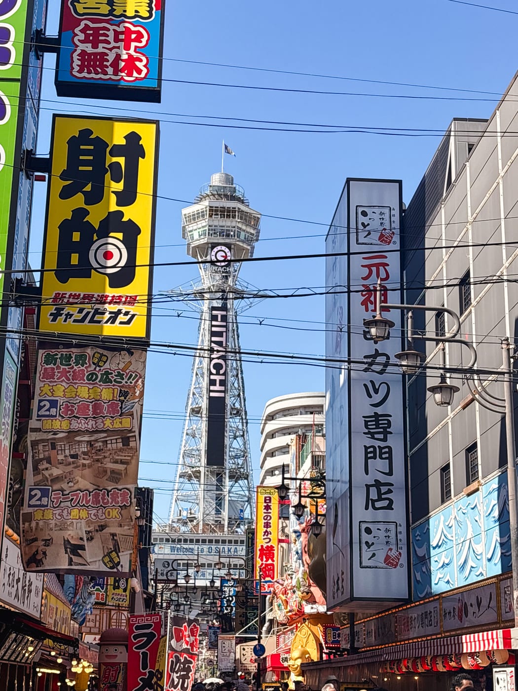 Tsutenkaku rising beyond the busy signs of Shinsekai