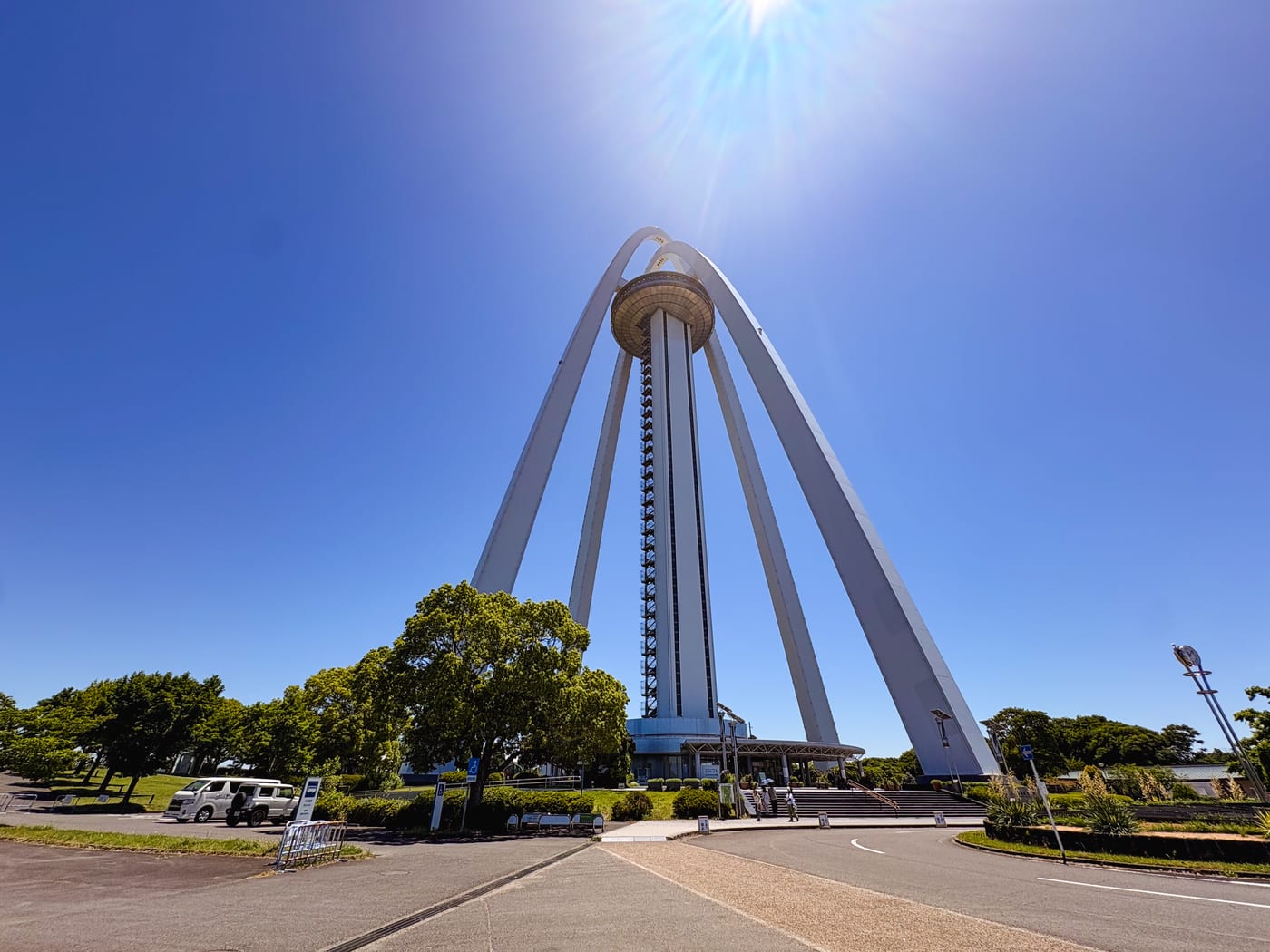 The white arch-shaped Twin Arch 138 under a blue sky