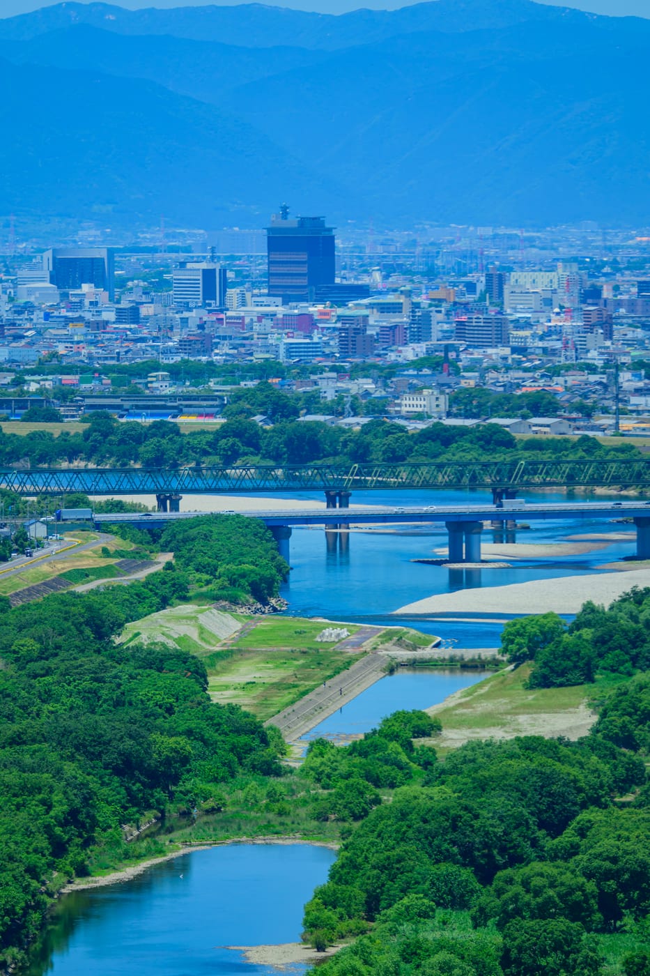 A river, bridges, and the city beyond as seen from Twin Arch 138
