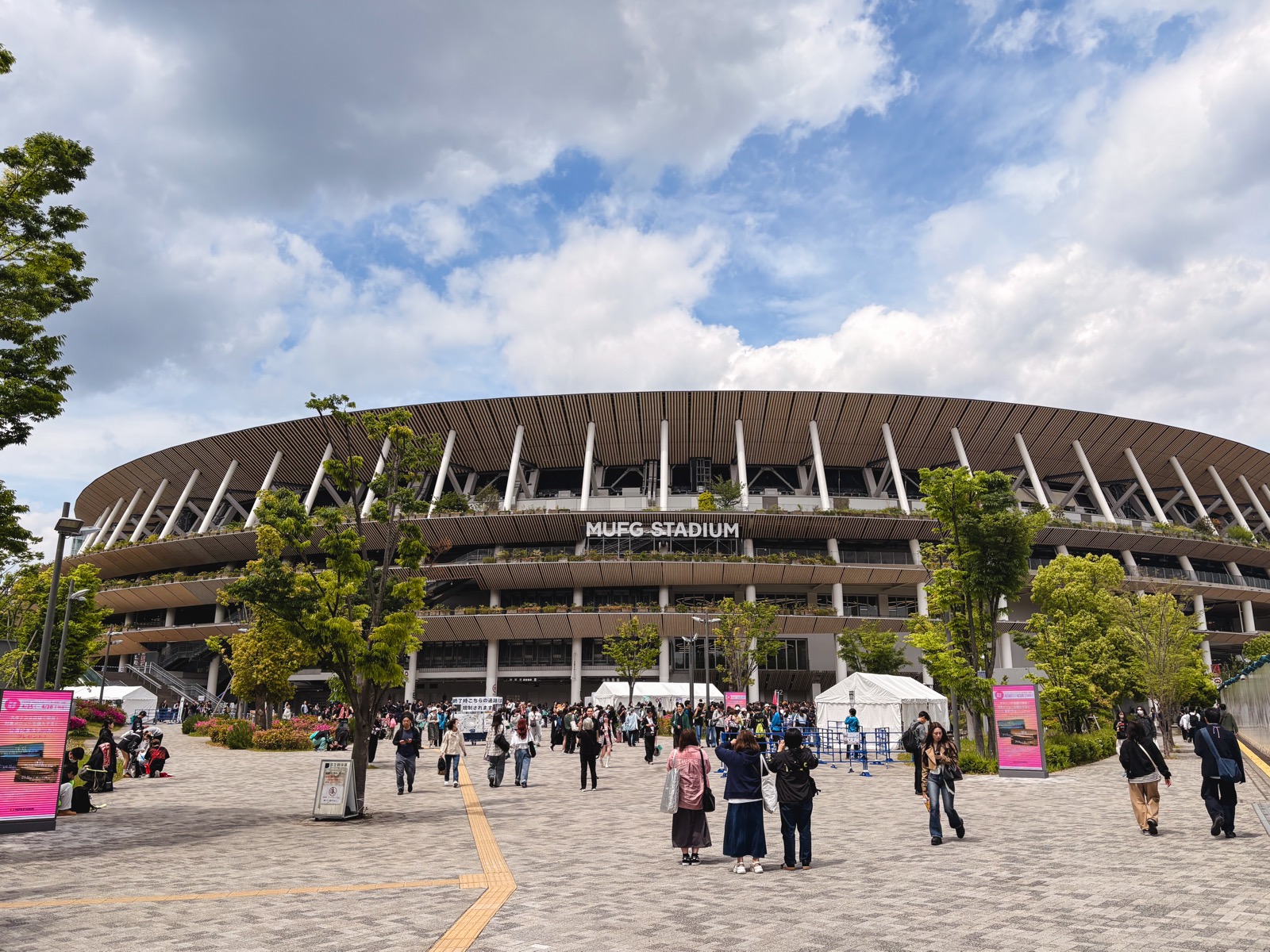 National Stadium under a blue sky with concertgoers waiting for the TWICE show