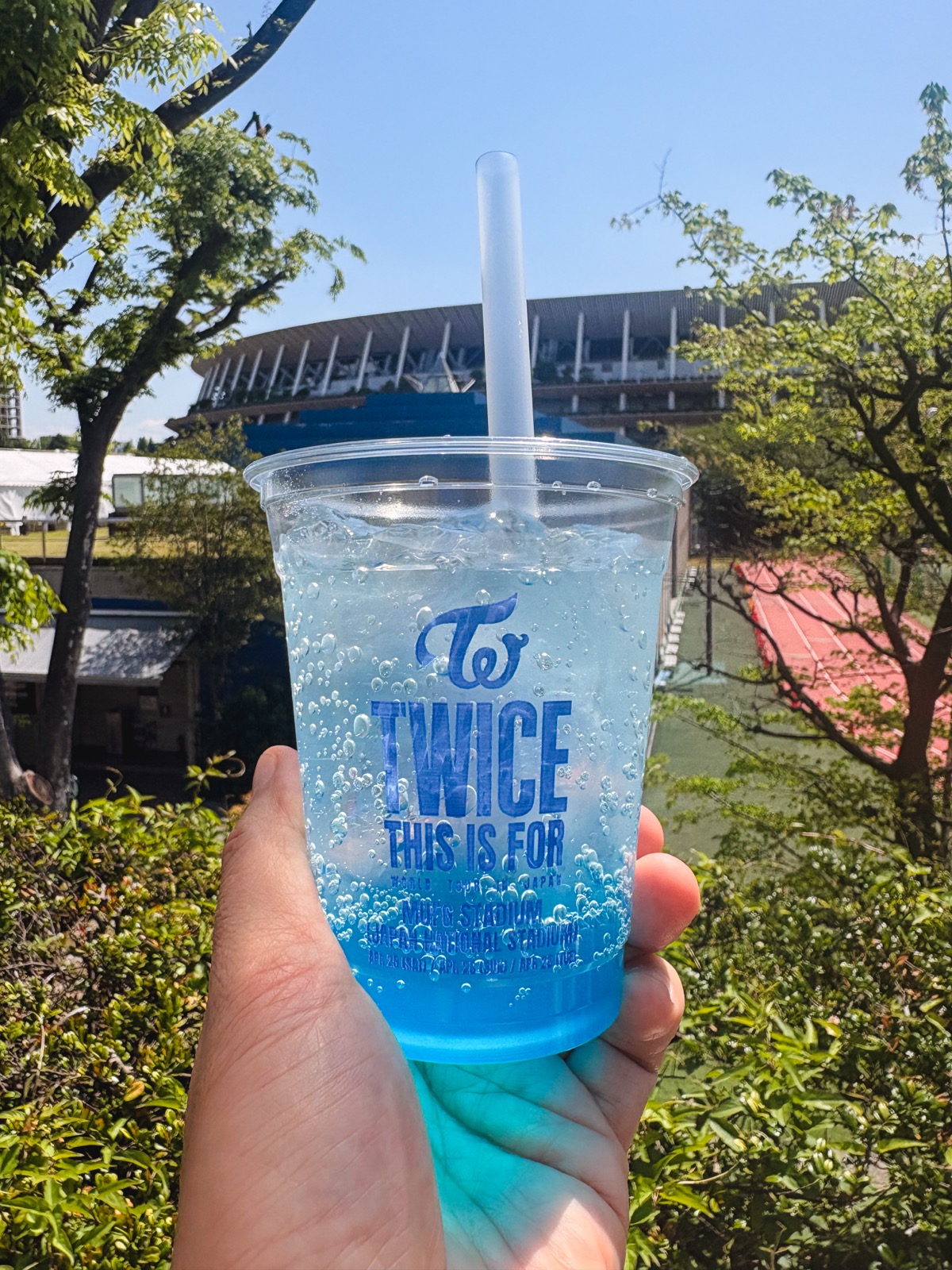 Blue TWICE THIS IS FOR drink with National Stadium in the background