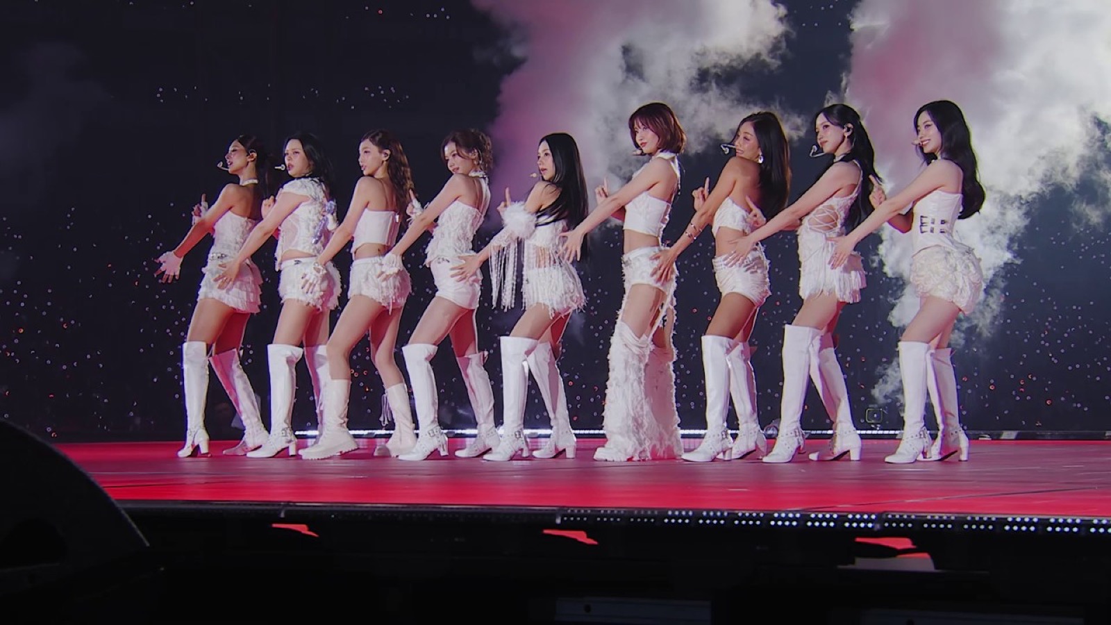 All 9 members of TWICE lined up in white outfits at the Tokyo Dome show