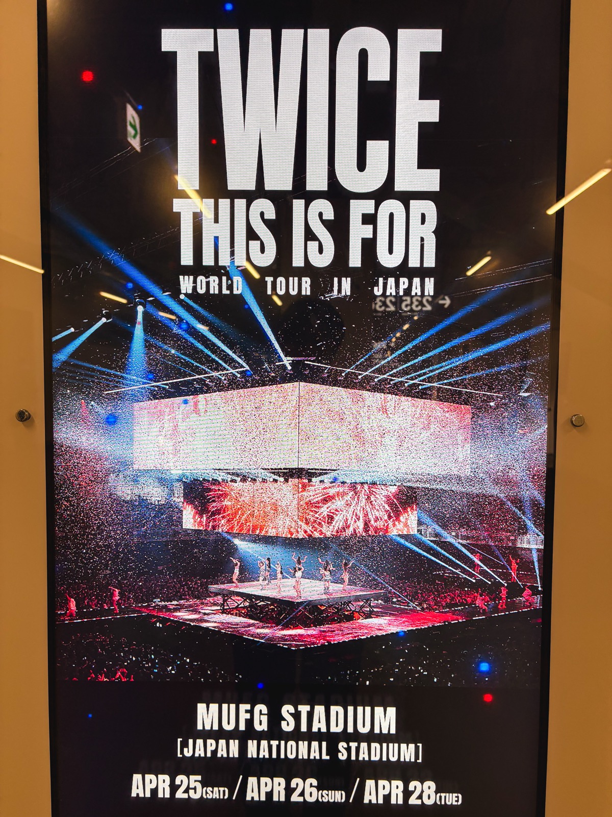 Venue screen showing the words TWICE THIS IS FOR WORLD TOUR and a packed stadium